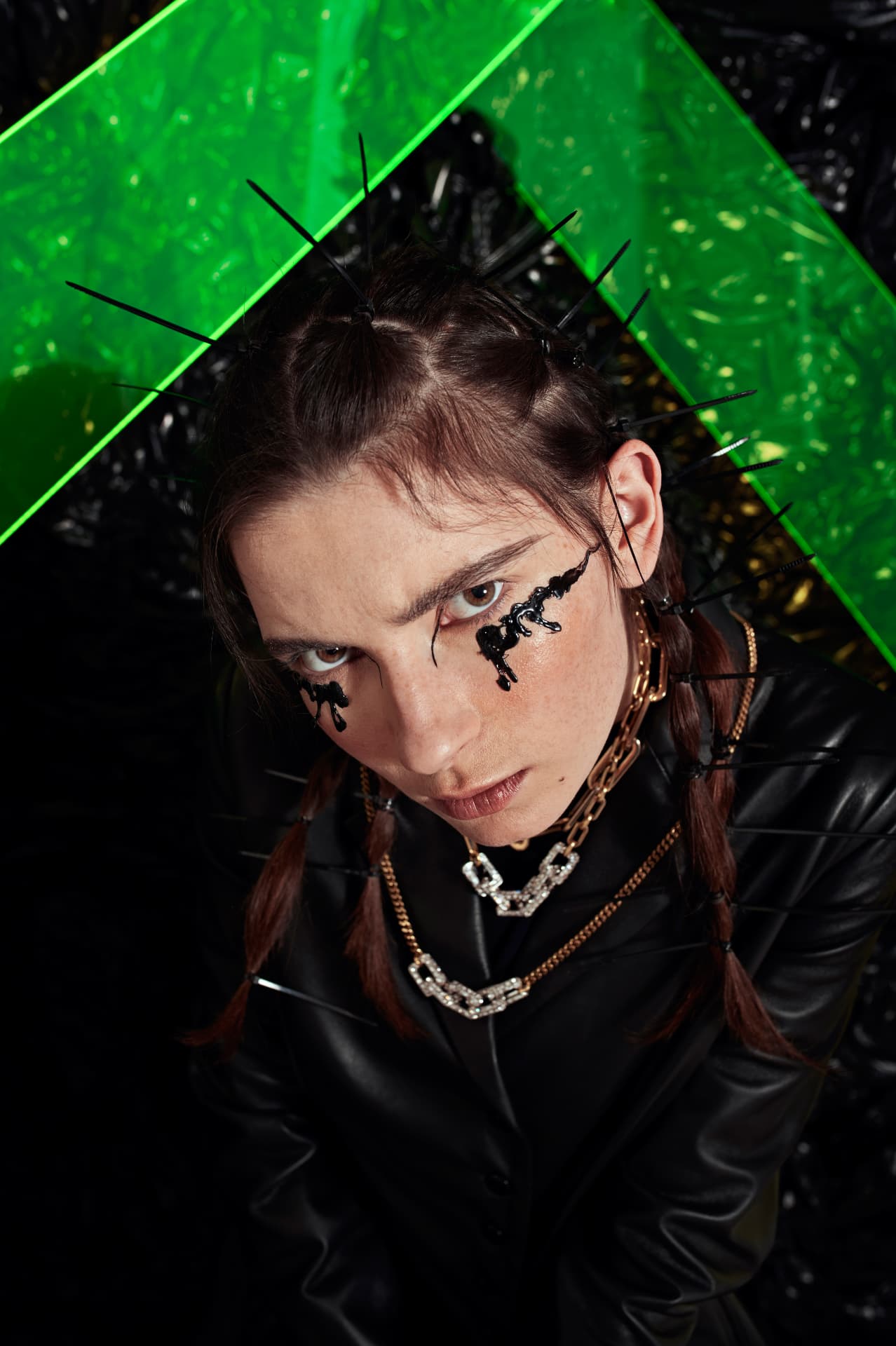 Dark portrait in a black glossy environment, acid green as the only interruption